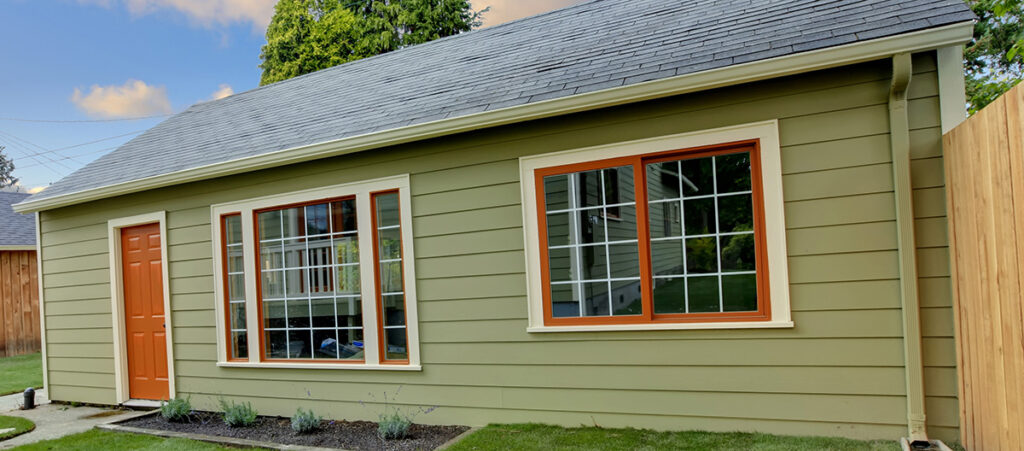 A small, single story home with two large windows.