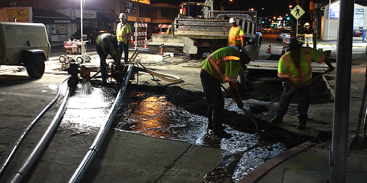 Crew repairing a broken water pipe
